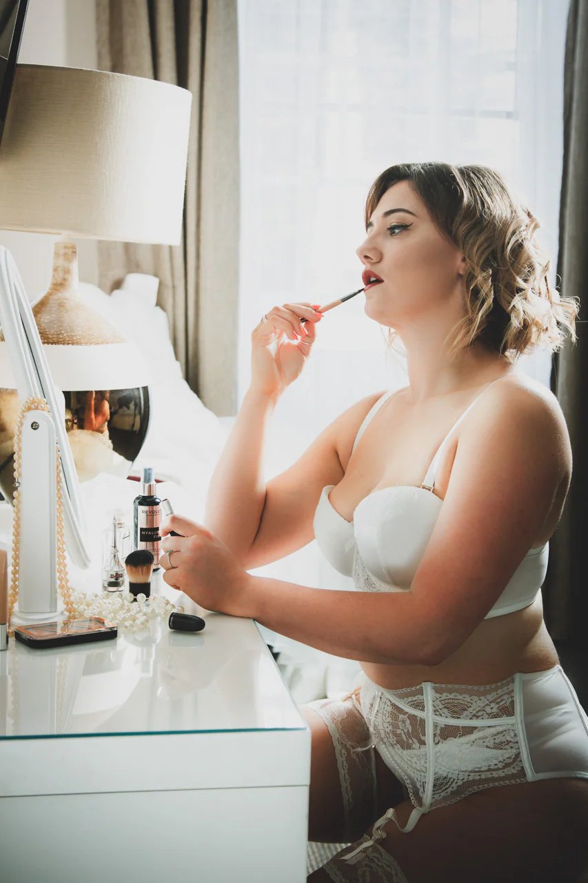 Bride preparing in white bridal lingerie for an Elland-Vee boudoir portrait