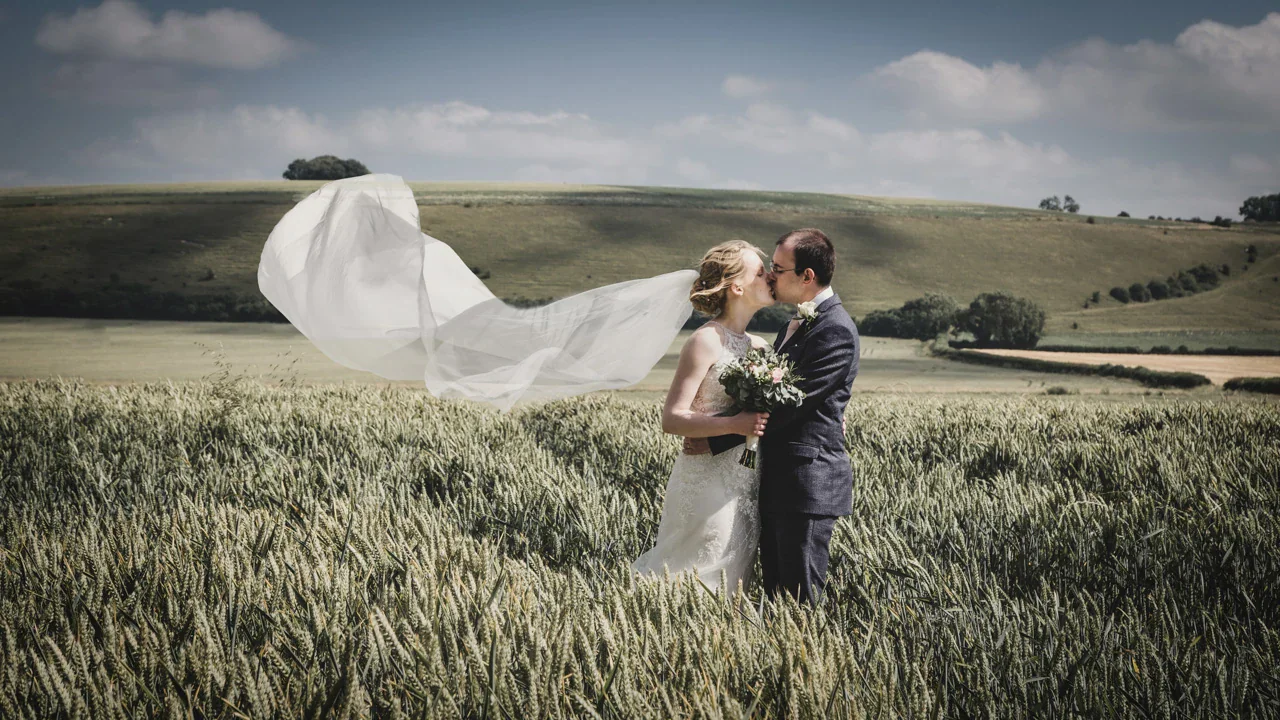 Newly married couple together in a Wiltshire landscape